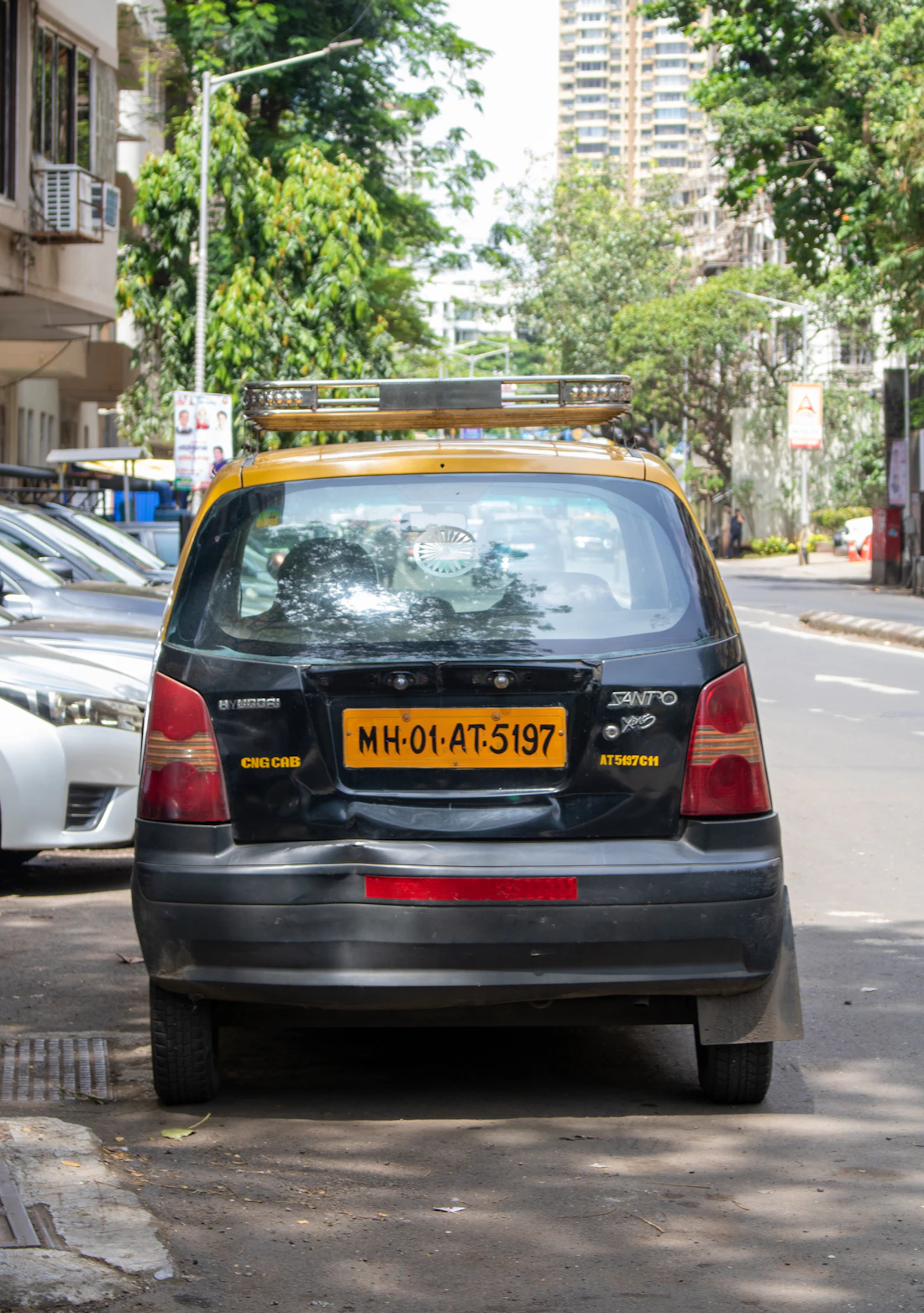Mumbai black and yellow taxi parked