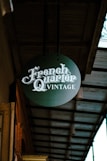 A sign hanging from the side of a building
