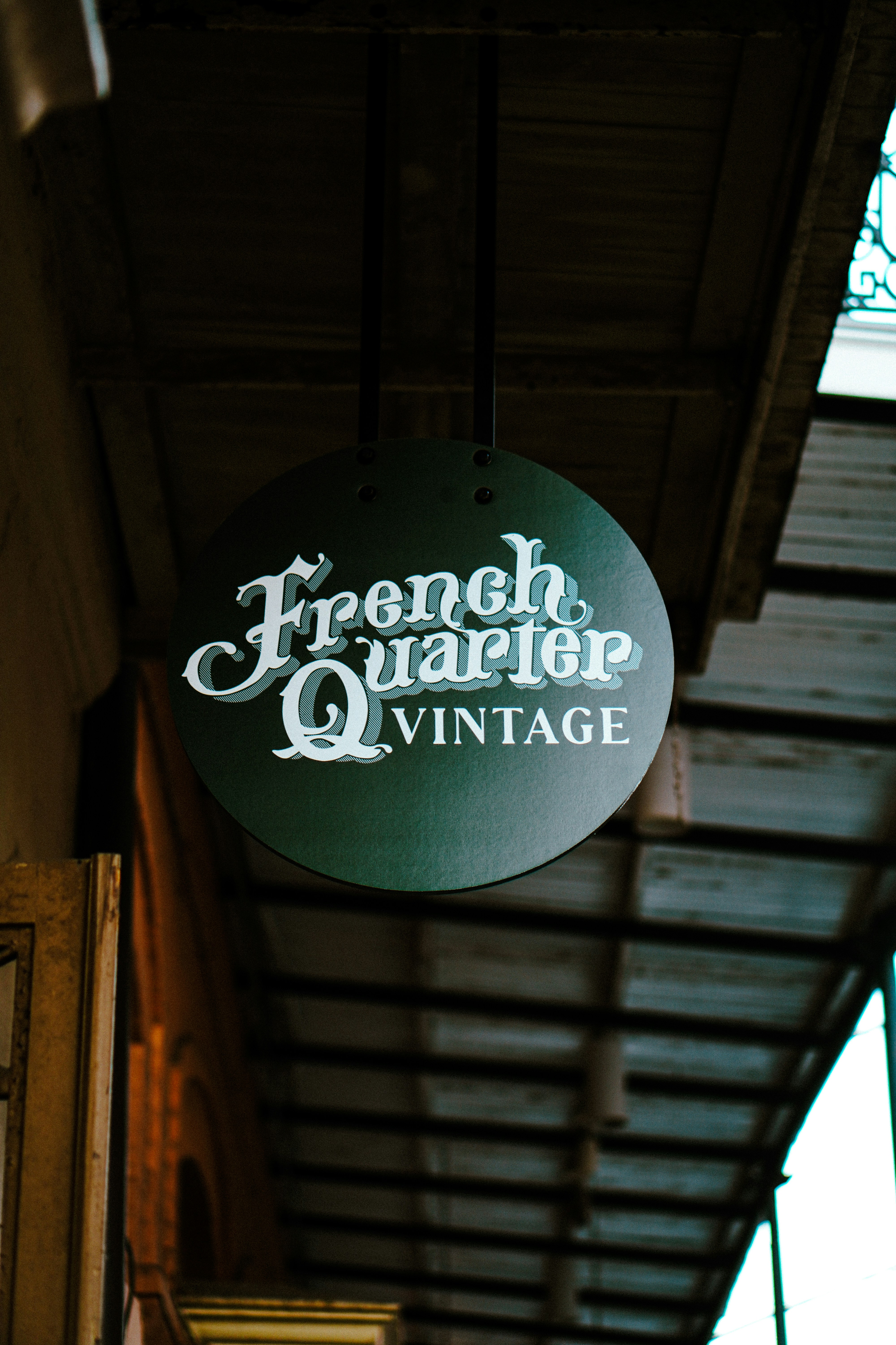 A sign hanging from the side of a building