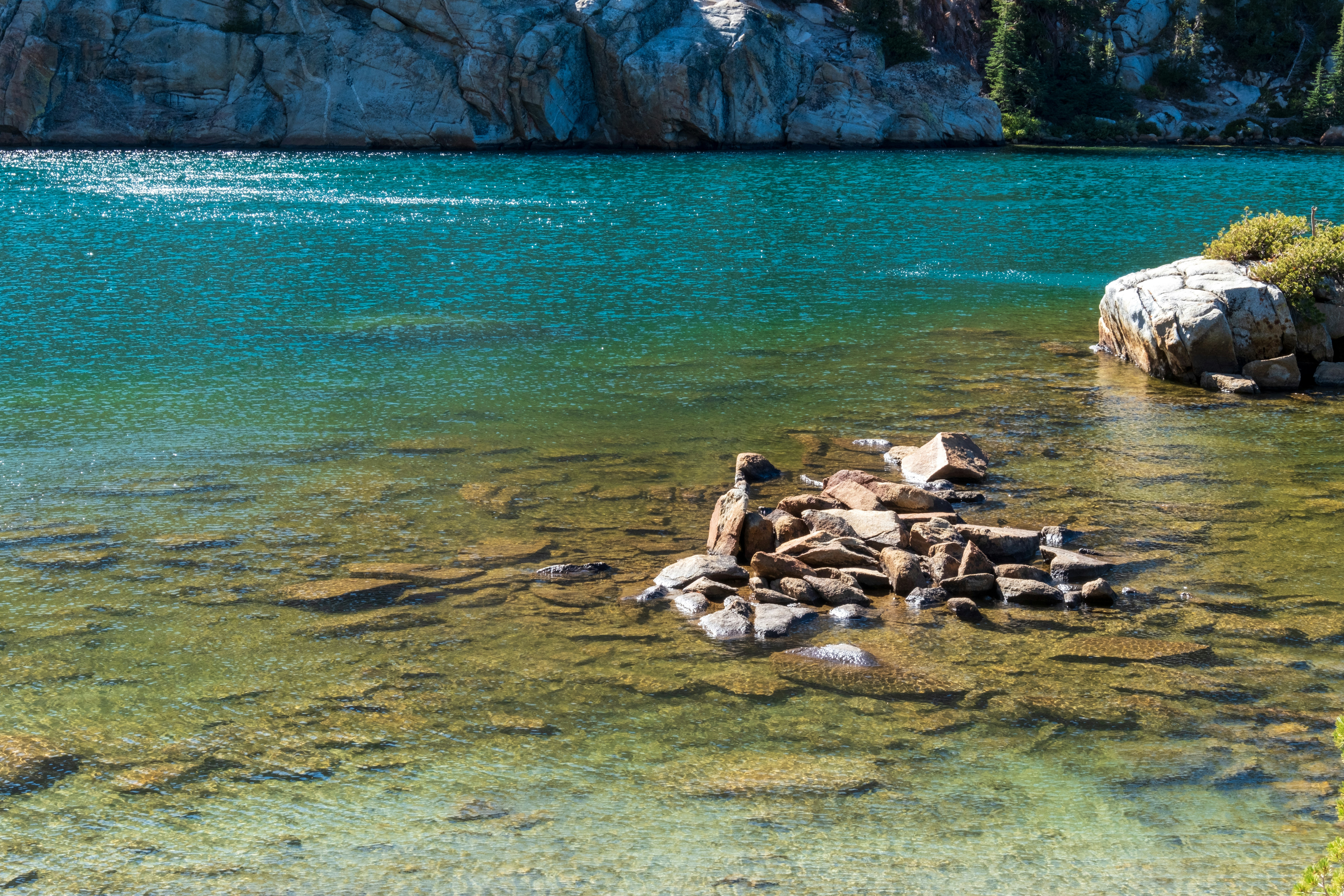 A large body of water with rocks in it