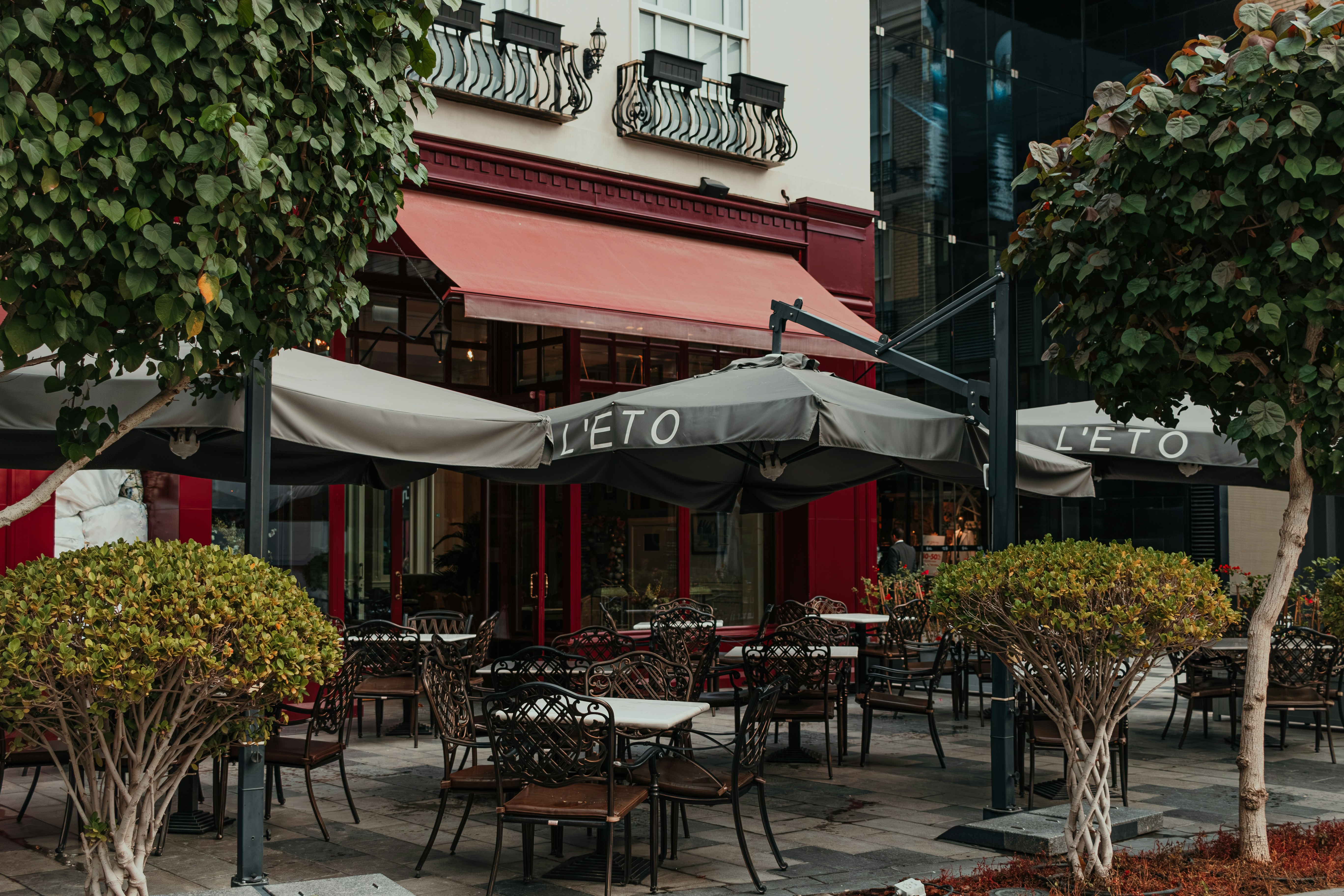 A group of tables and chairs outside of a restaurant