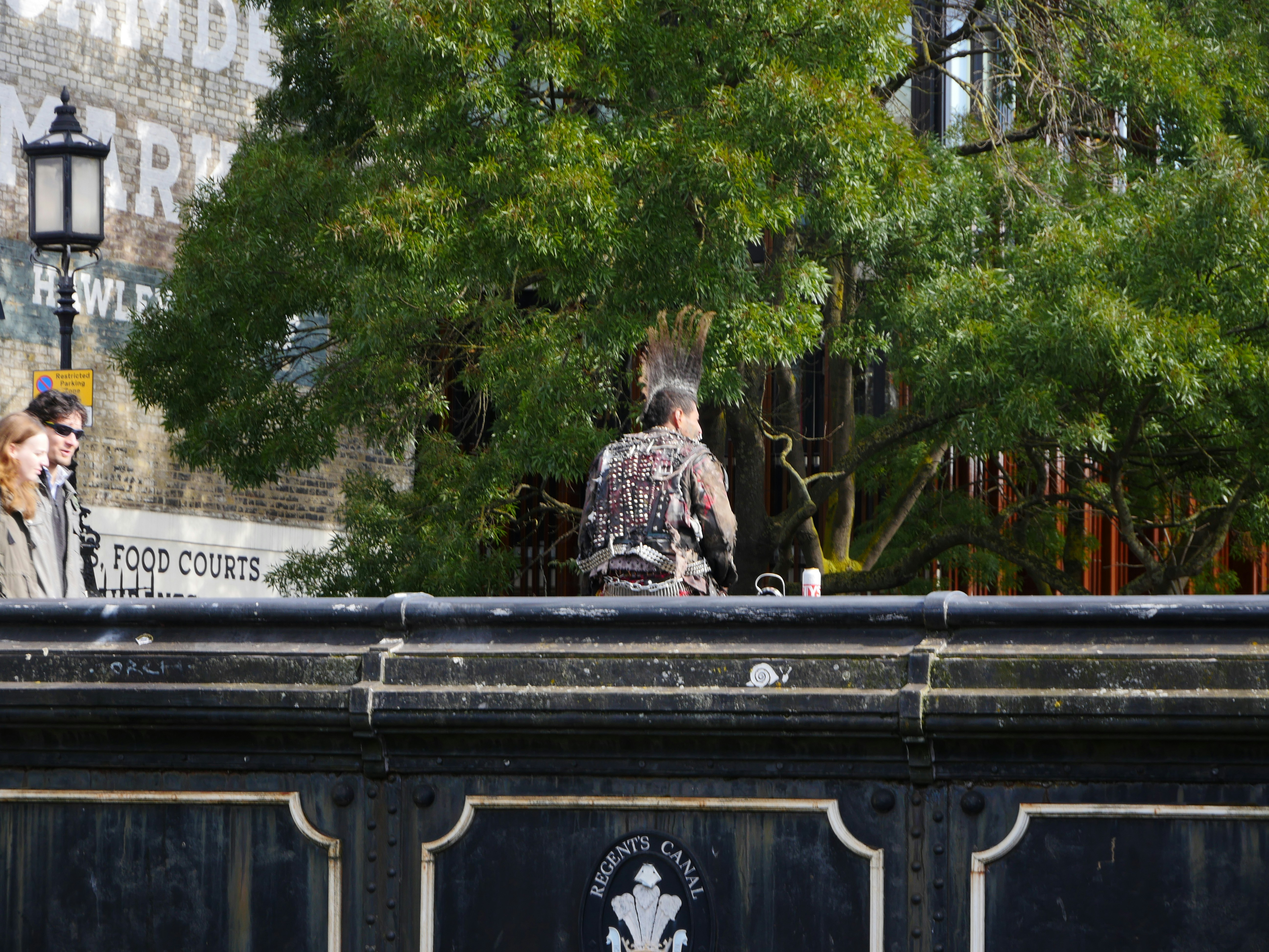 A couple of people standing on top of a bridge