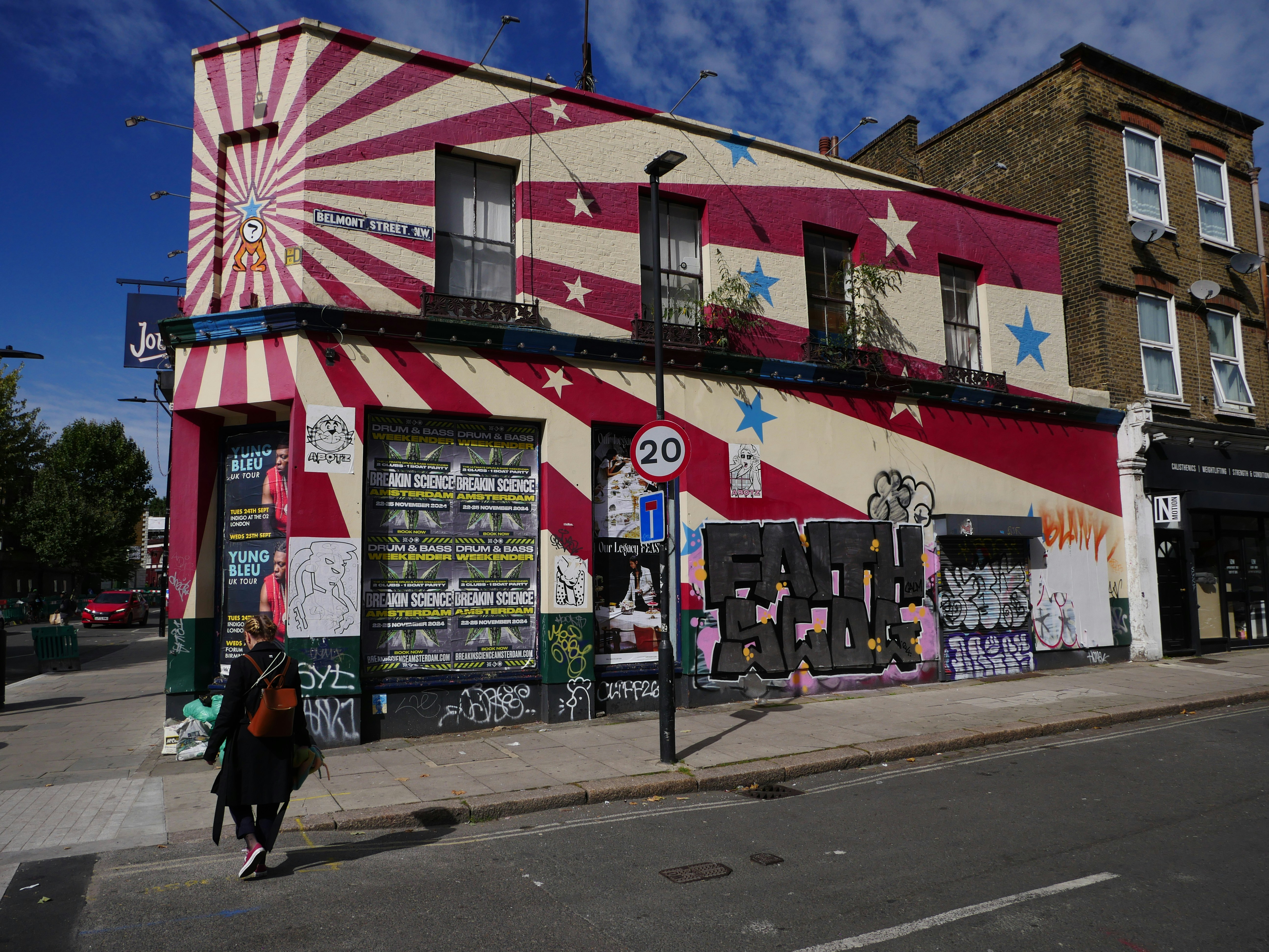 A building with a circus theme painted on the side of it