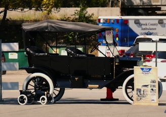 An old fashioned car parked in a parking lot