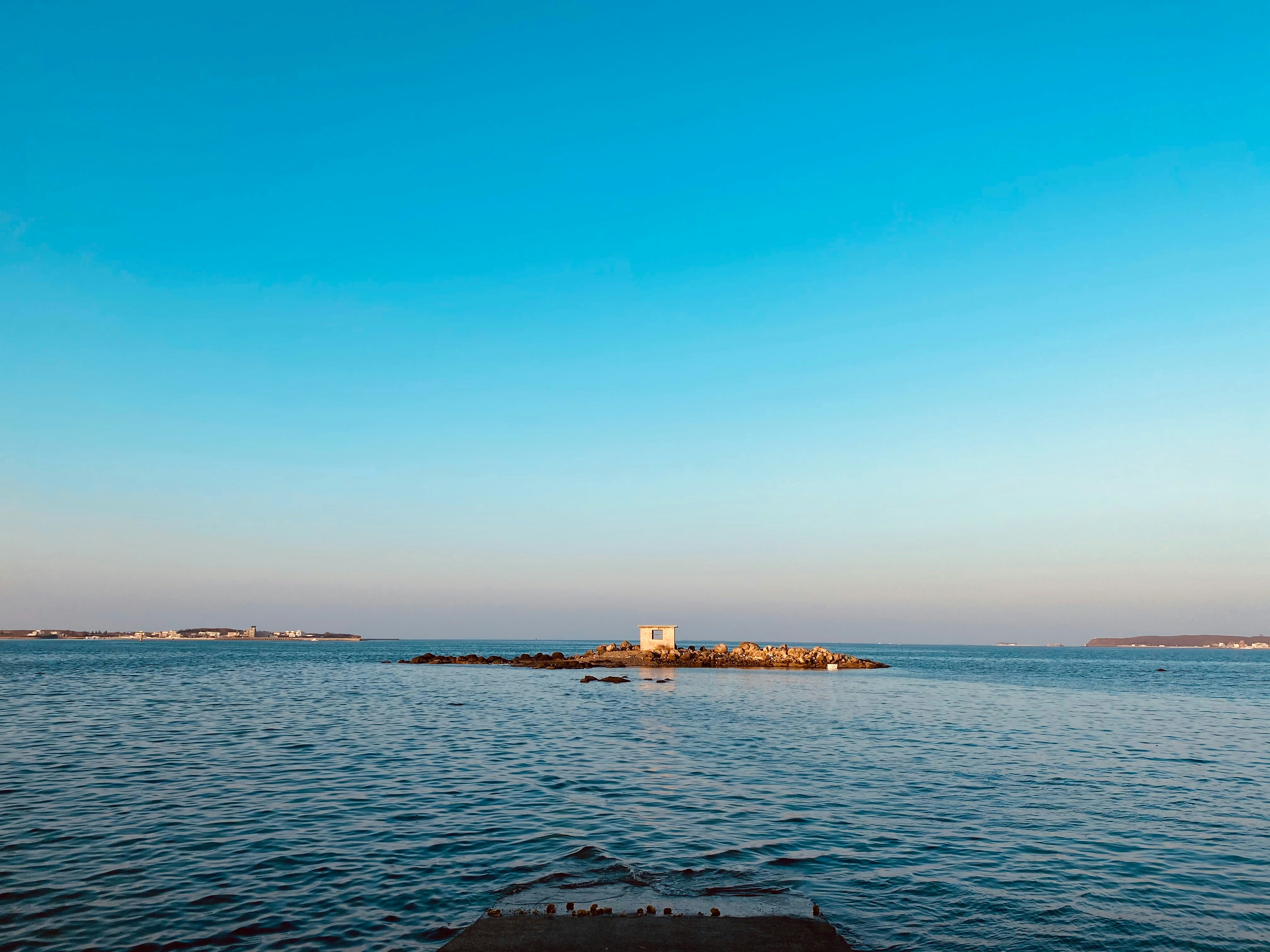 A body of water with a small island in the distance