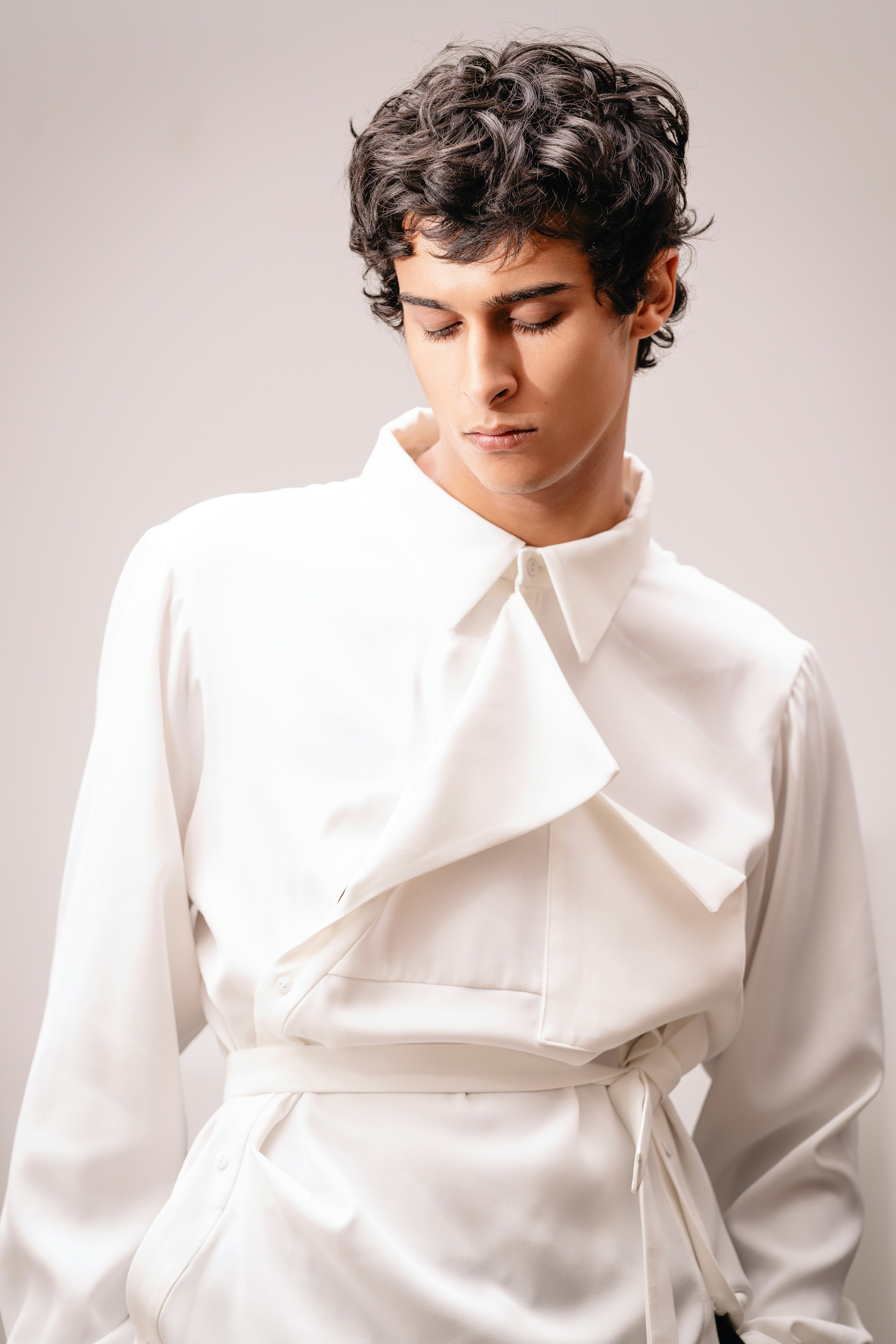 A man wearing a white shirt and black pants