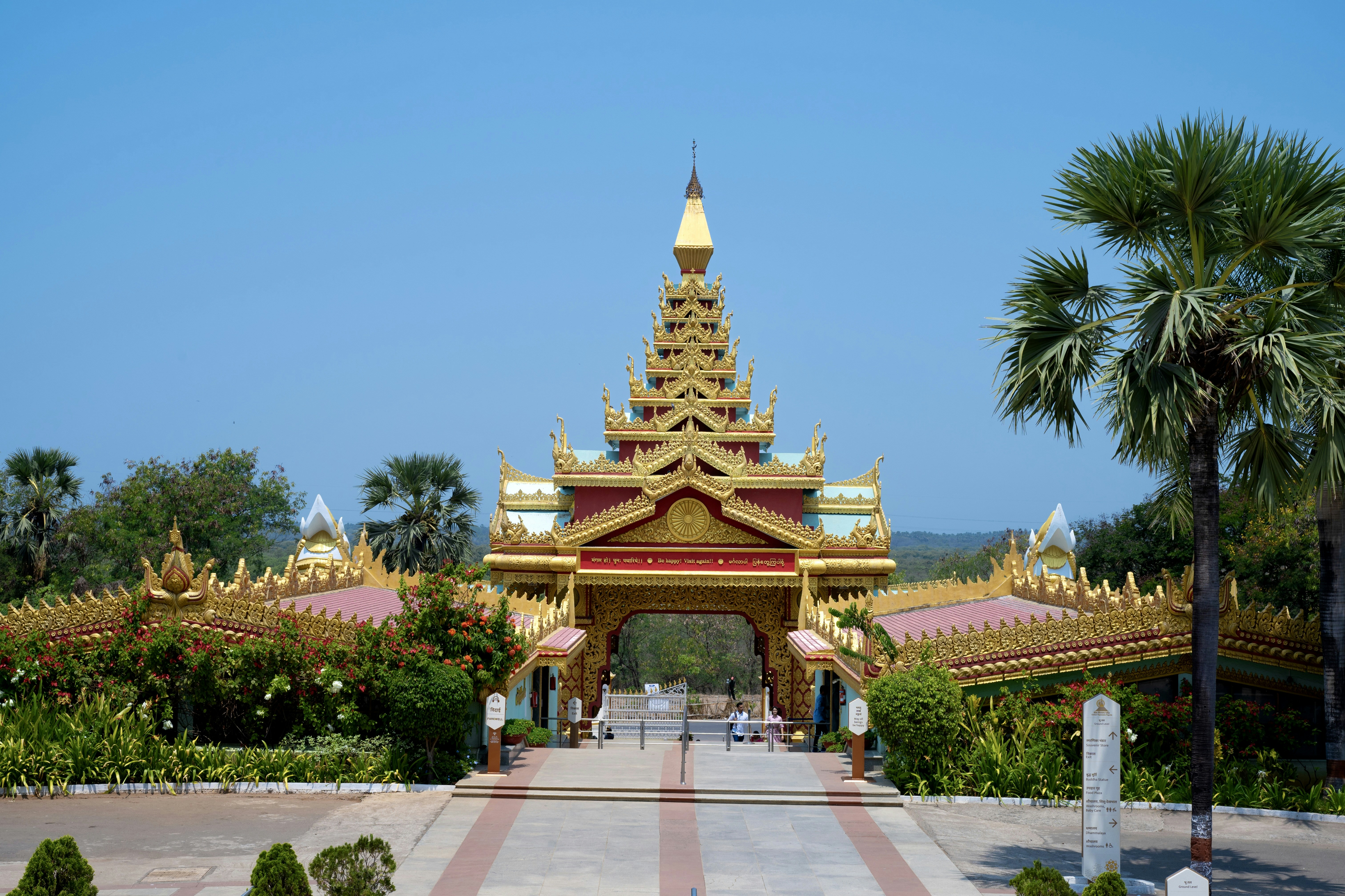 Golden Buddhist temple at sunrise, soft warm light, peaceful atmosphere, orange and gold tones
