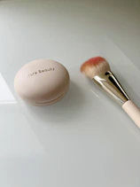 A brush and a powder on a table