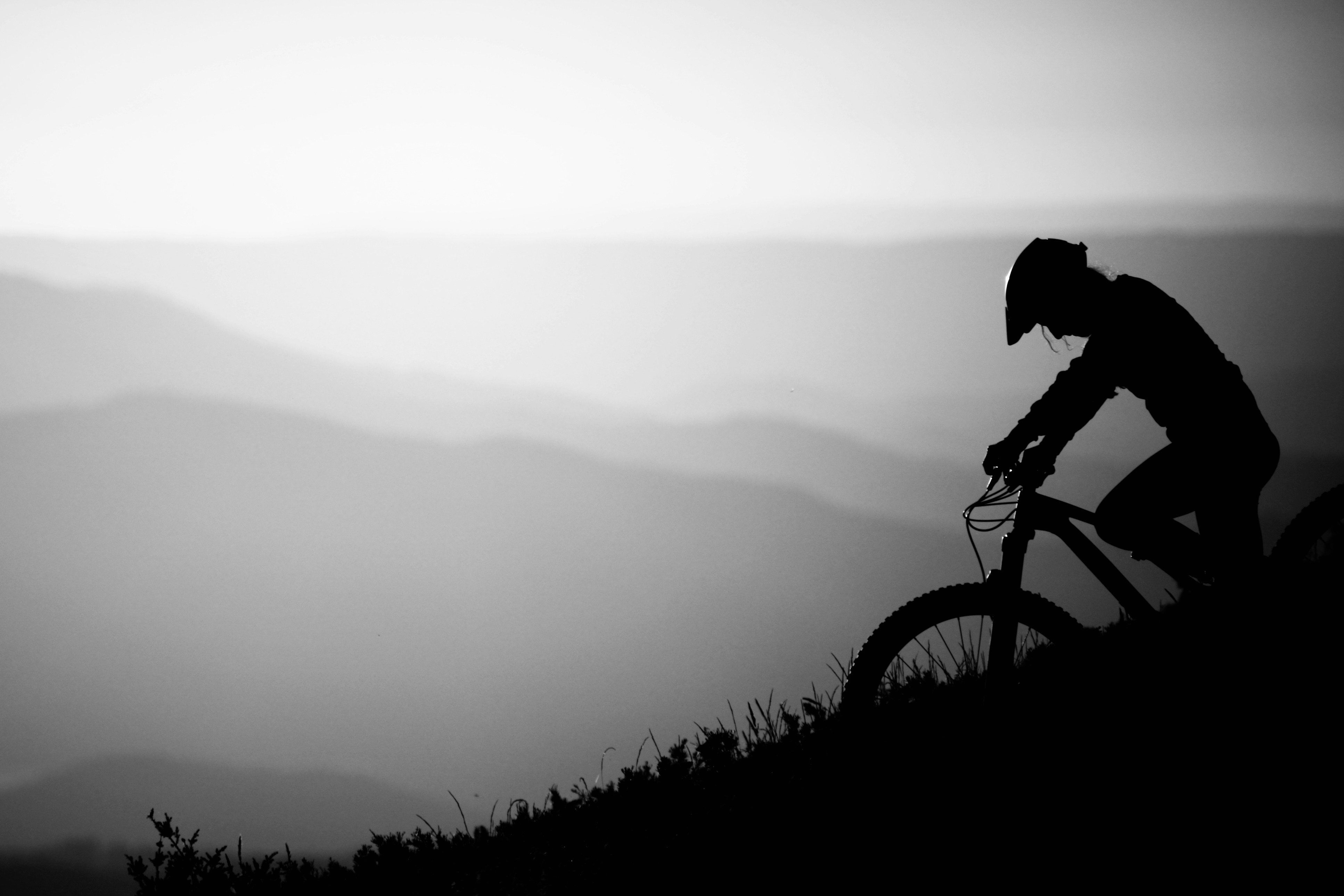 A man riding a bike down a hill