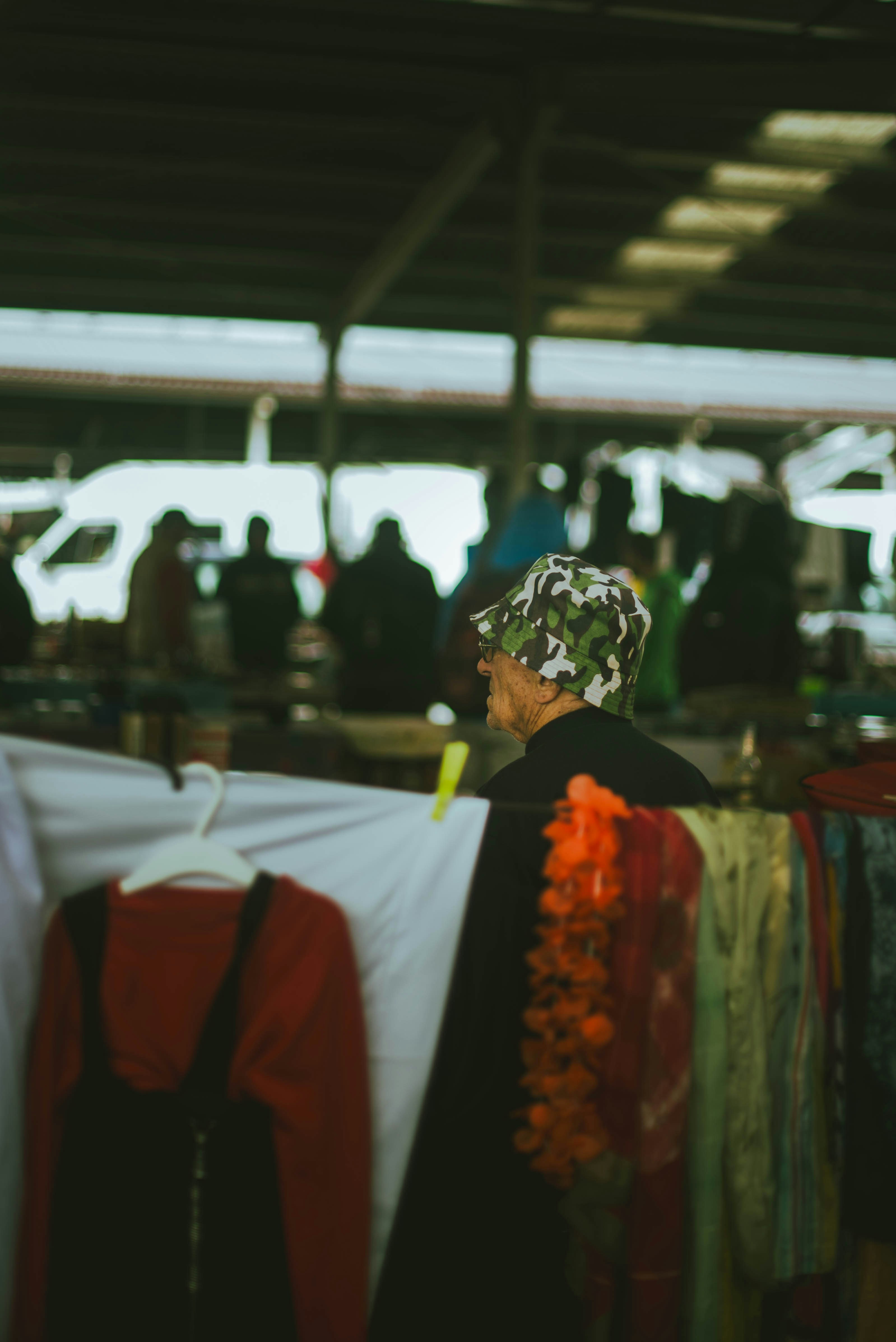 A woman standing in front of a rack of clothes