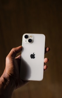 A person holding an iPhone in their hand