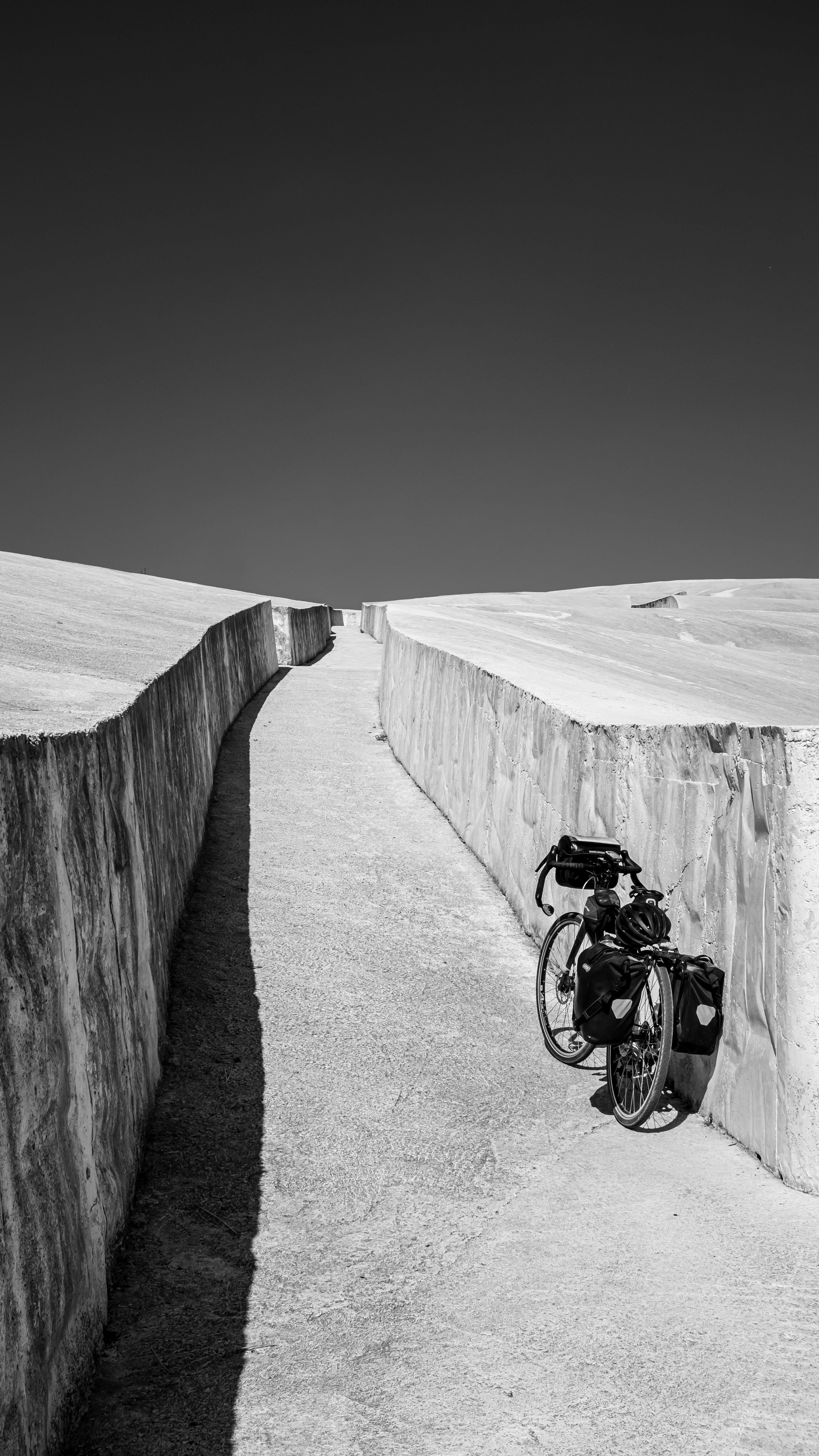A bike leaning against a concrete wall