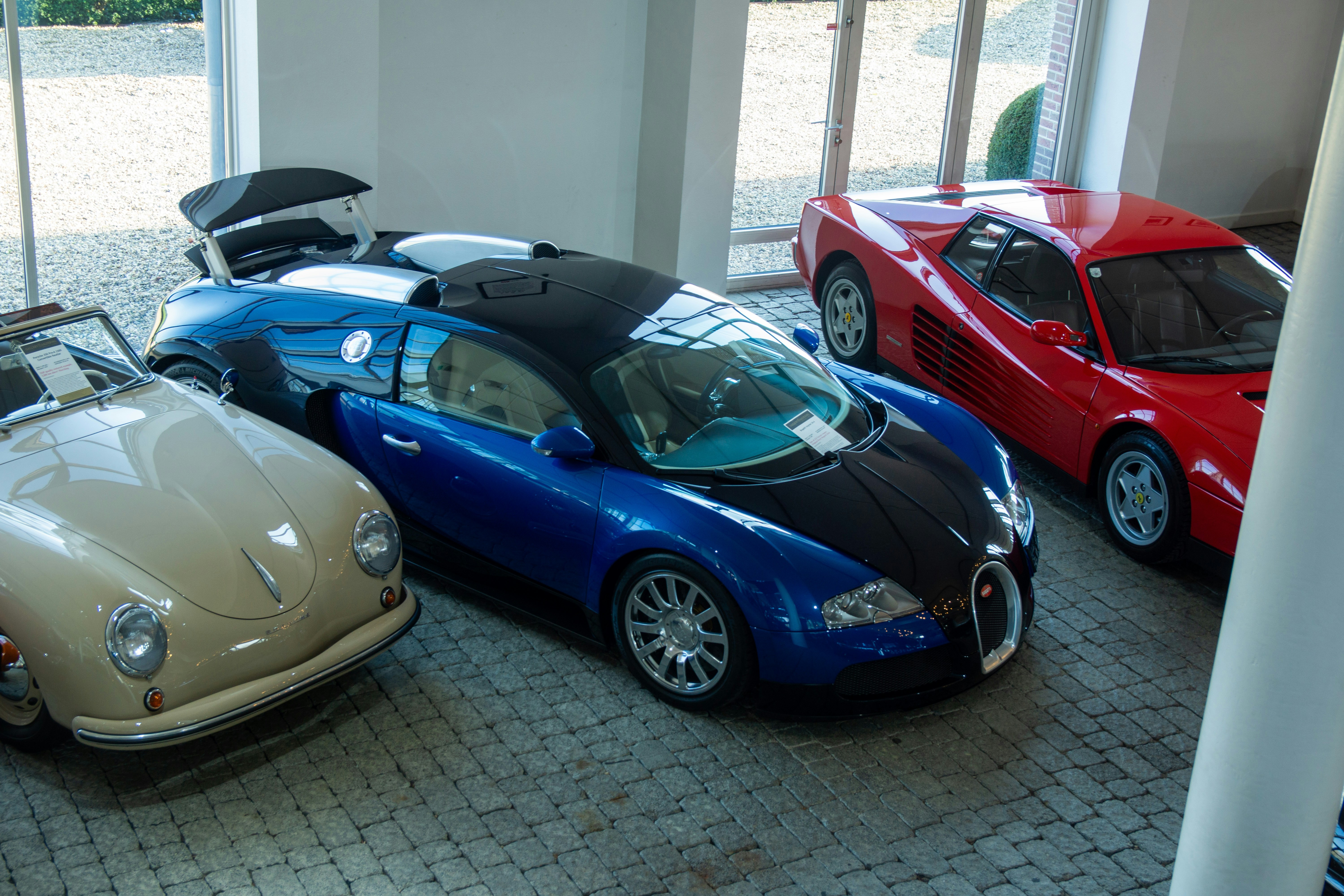 A group of cars parked inside of a garage