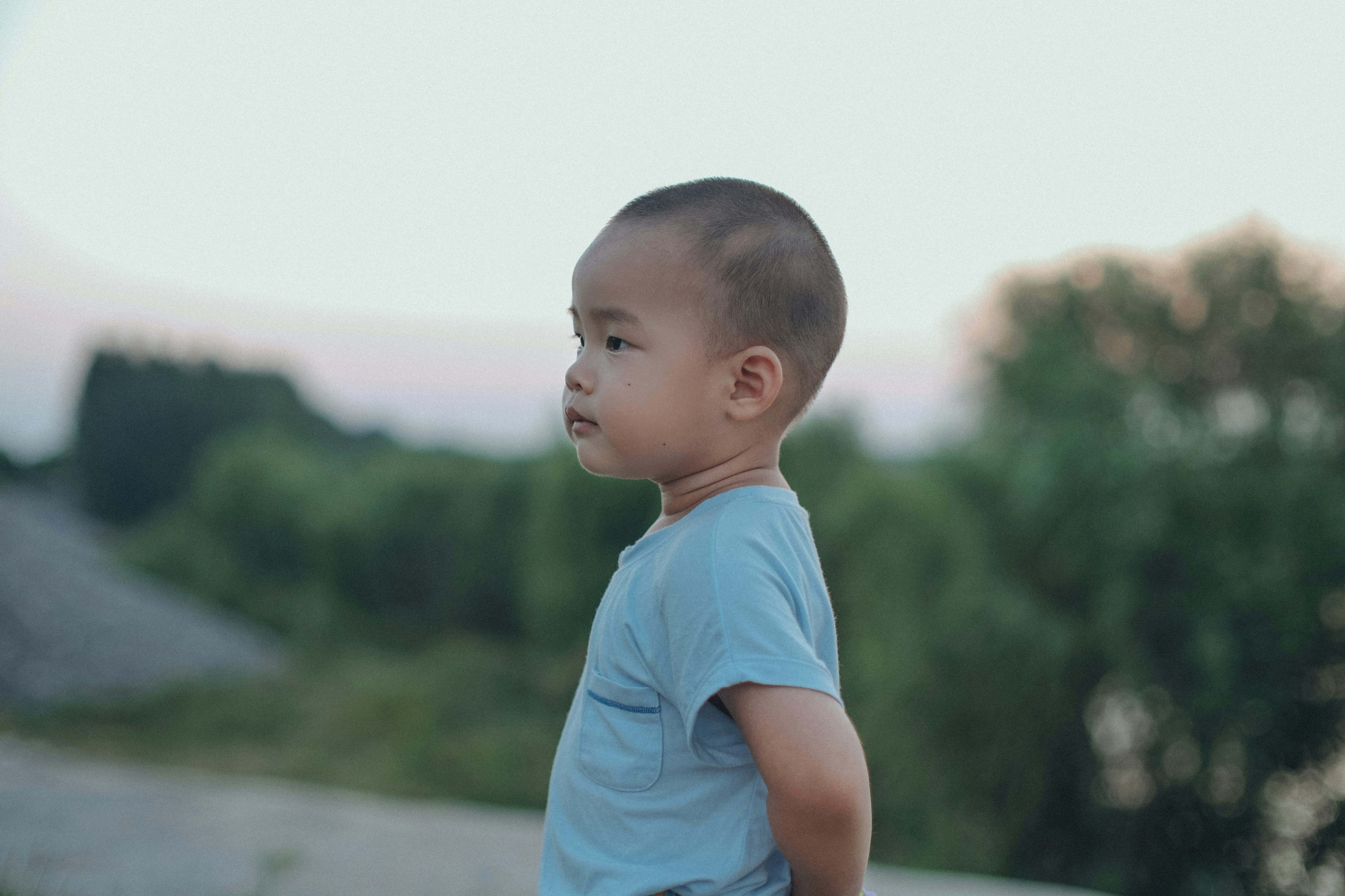 A little boy that is standing in the grass