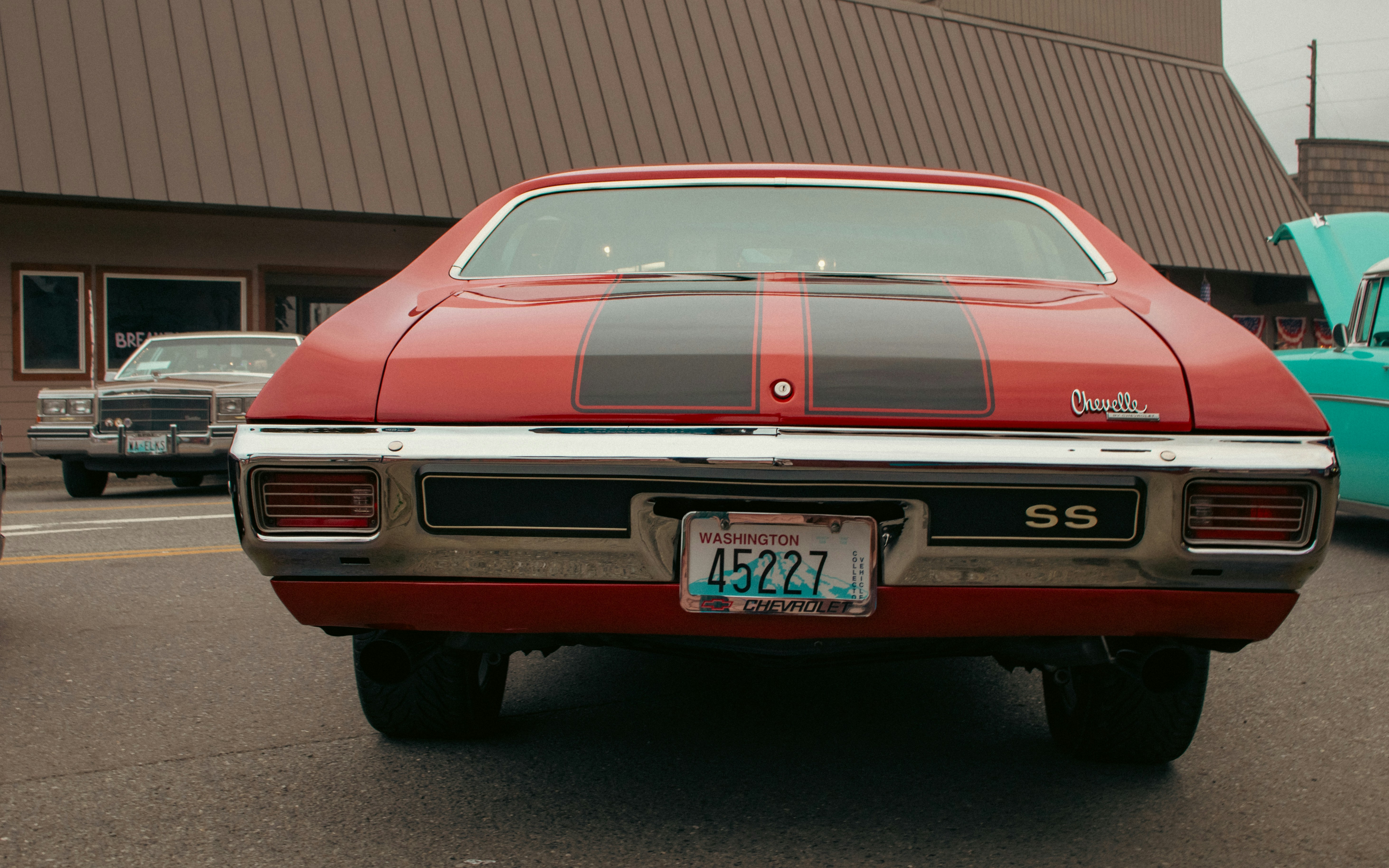A red and black car parked in a parking lot
