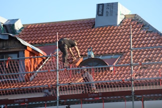 A man on a roof working on a roof