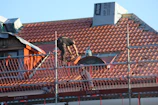 A man on a roof working on a roof