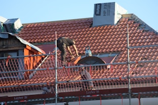 A man on a roof working on a roof