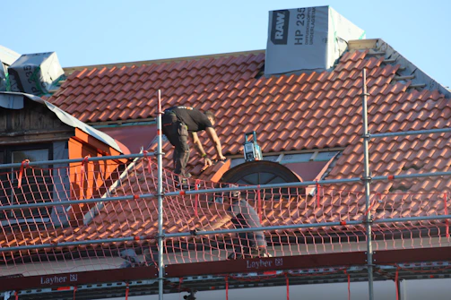 A man on a roof working on a roof