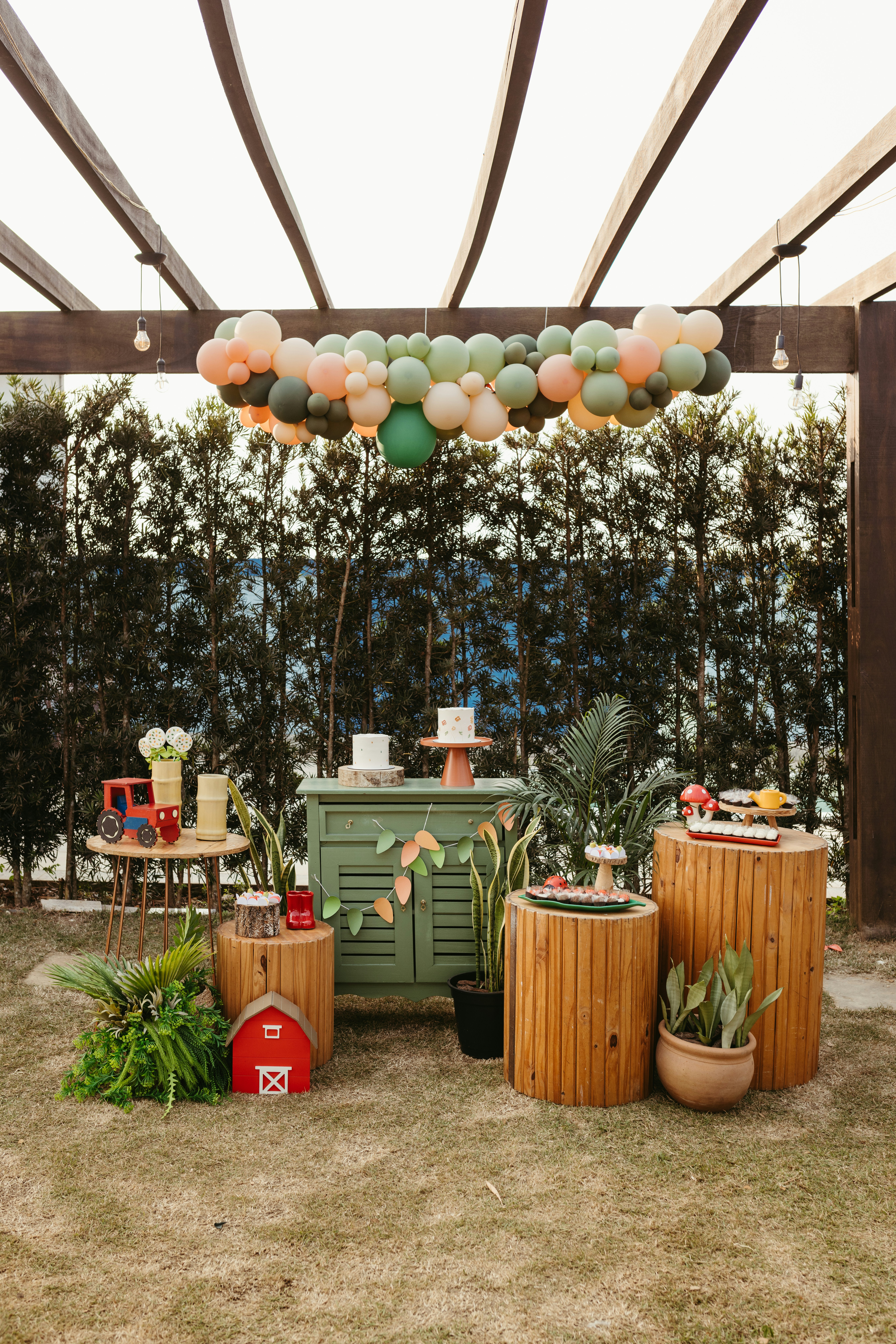 Luxurious birthday party setup with custom wooden centerpieces and floral arrangements