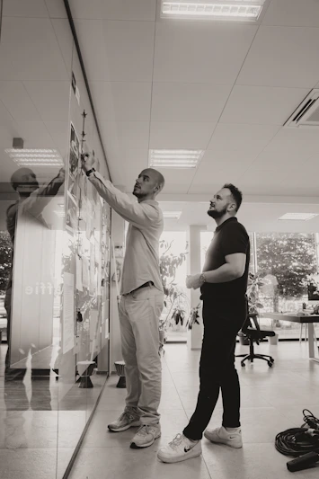 A couple of men standing next to each other