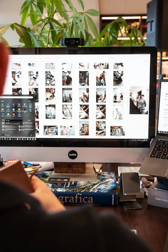 A man sitting in front of a computer on a desk