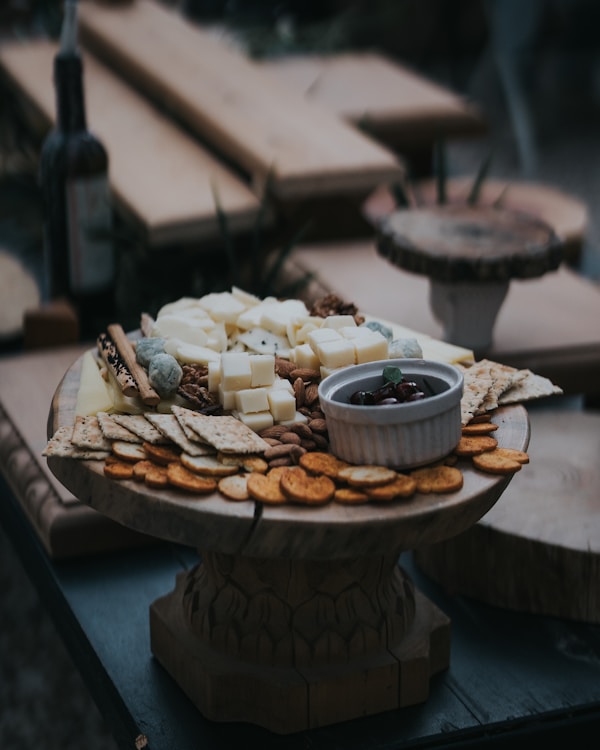 A platter of cheese and crackers on a table