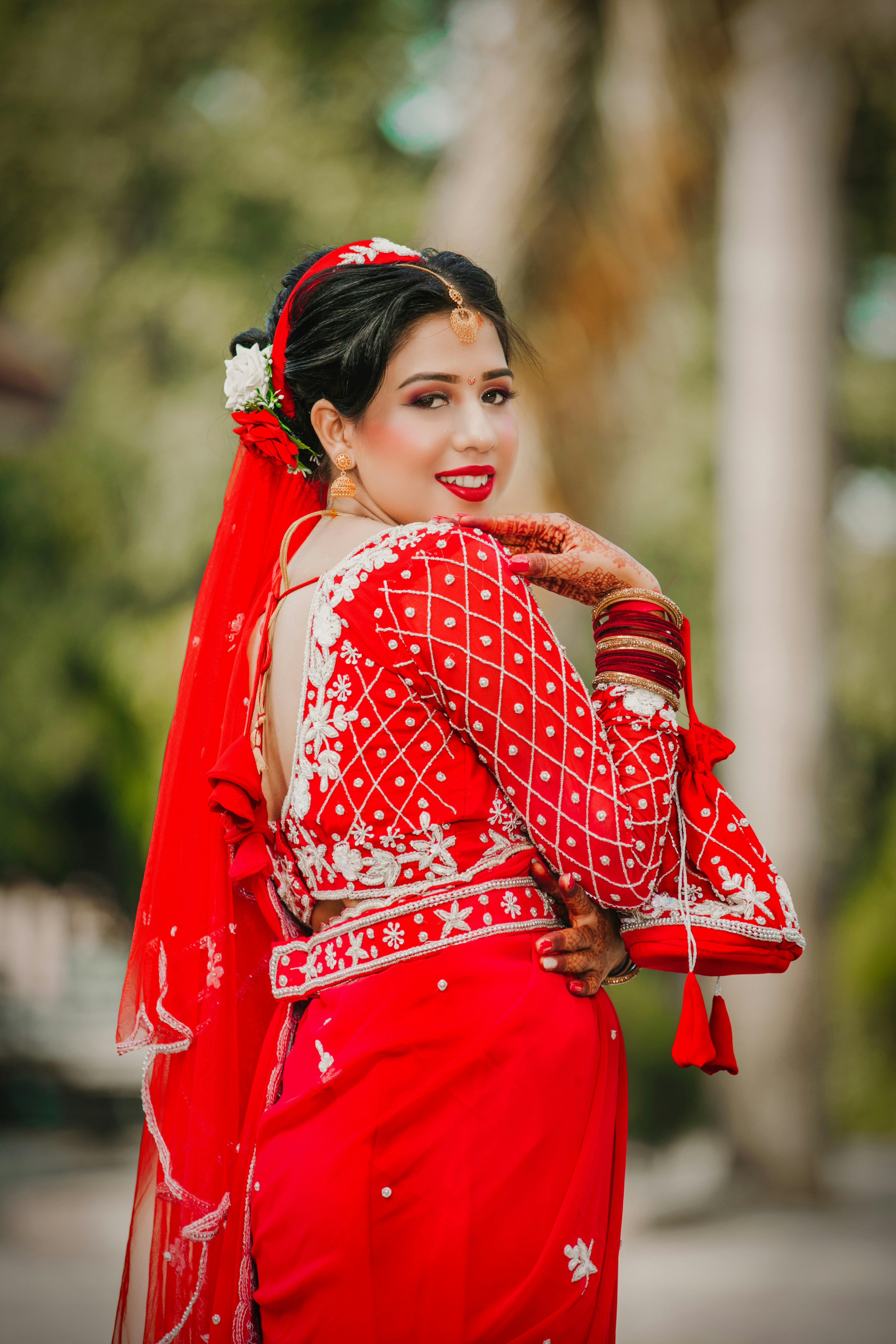 A woman in a red and white wedding outfit