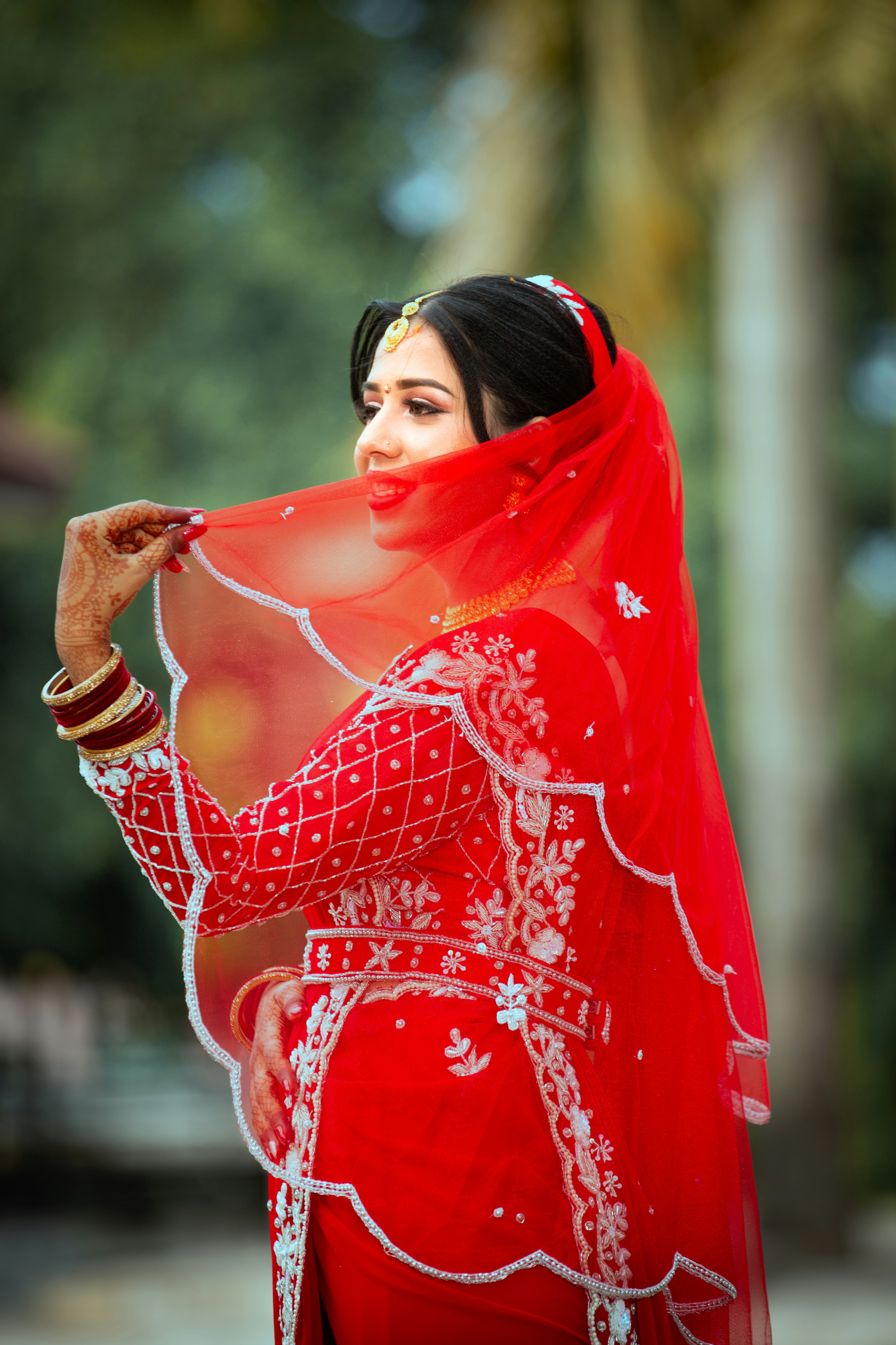 A woman in a red dress and a red shawl