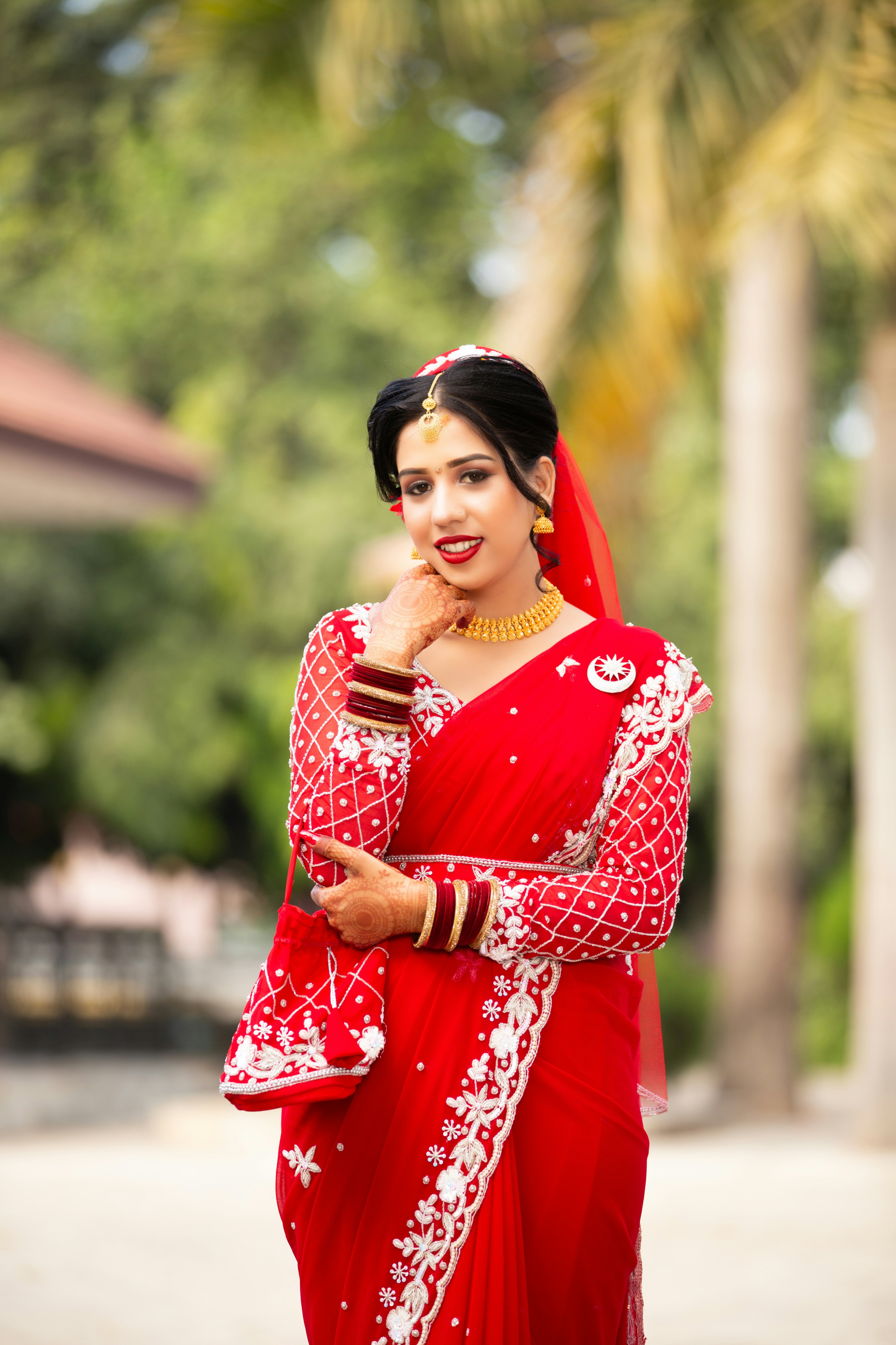 A woman in a red sari posing for a picture