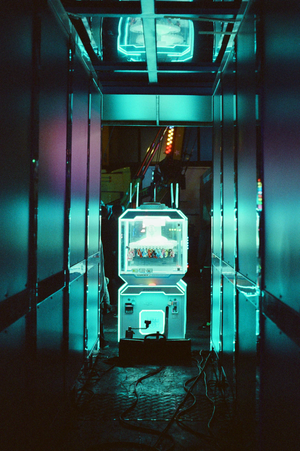 Futuristic arcade room with neon green and blue color scheme, filled with various arcade games