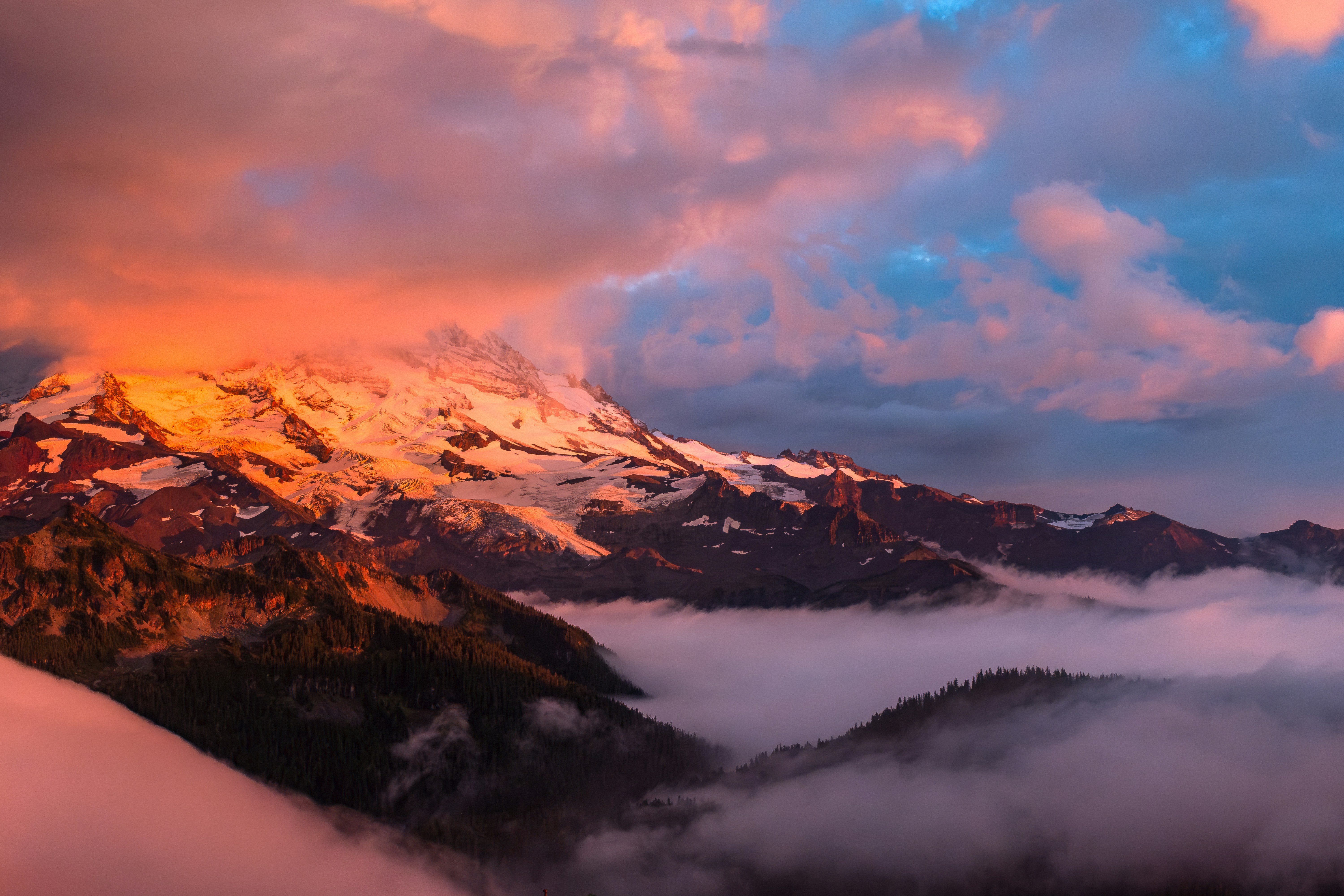 A mountain covered in clouds under a cloudy sky