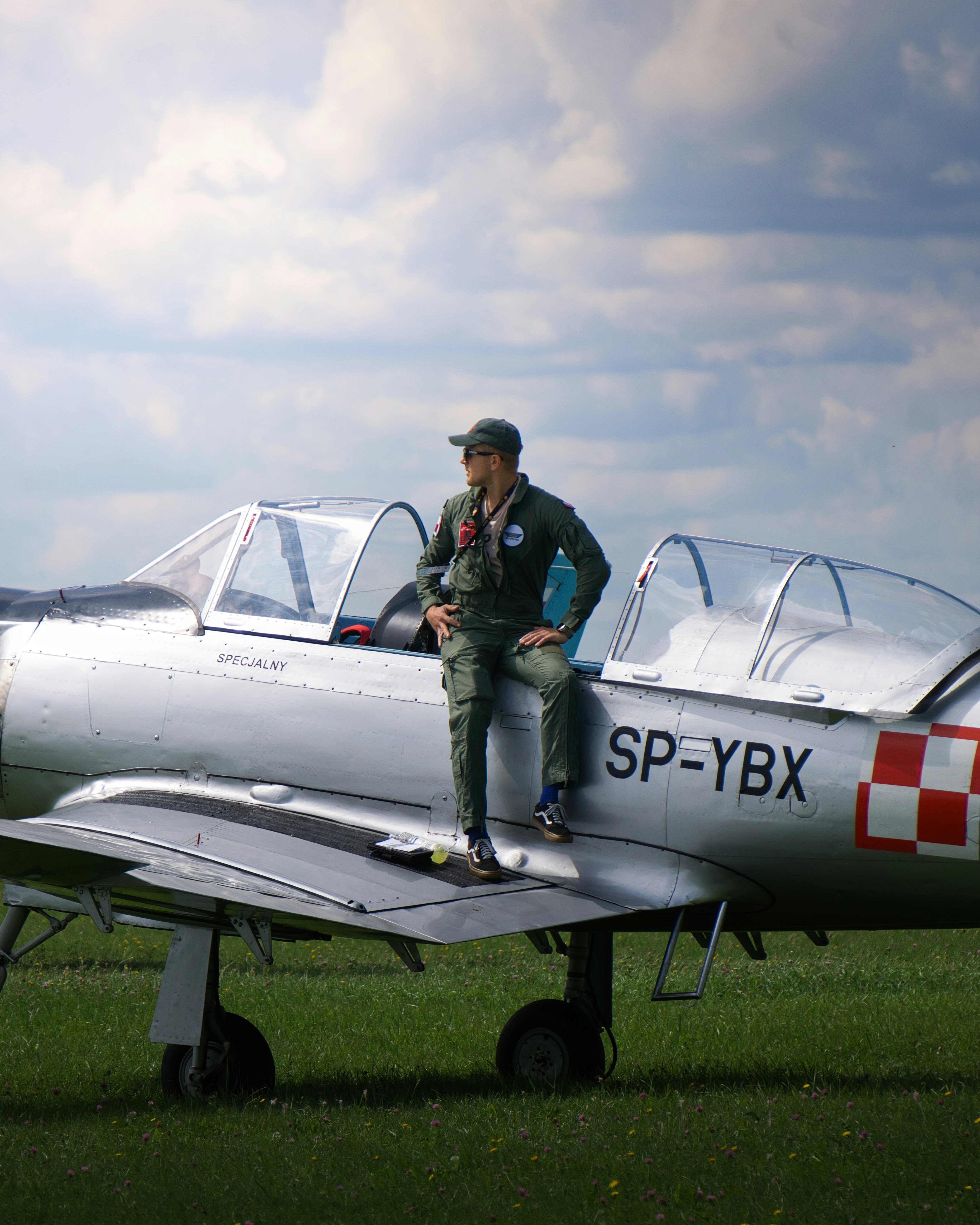 A man sitting on the wing of an airplane