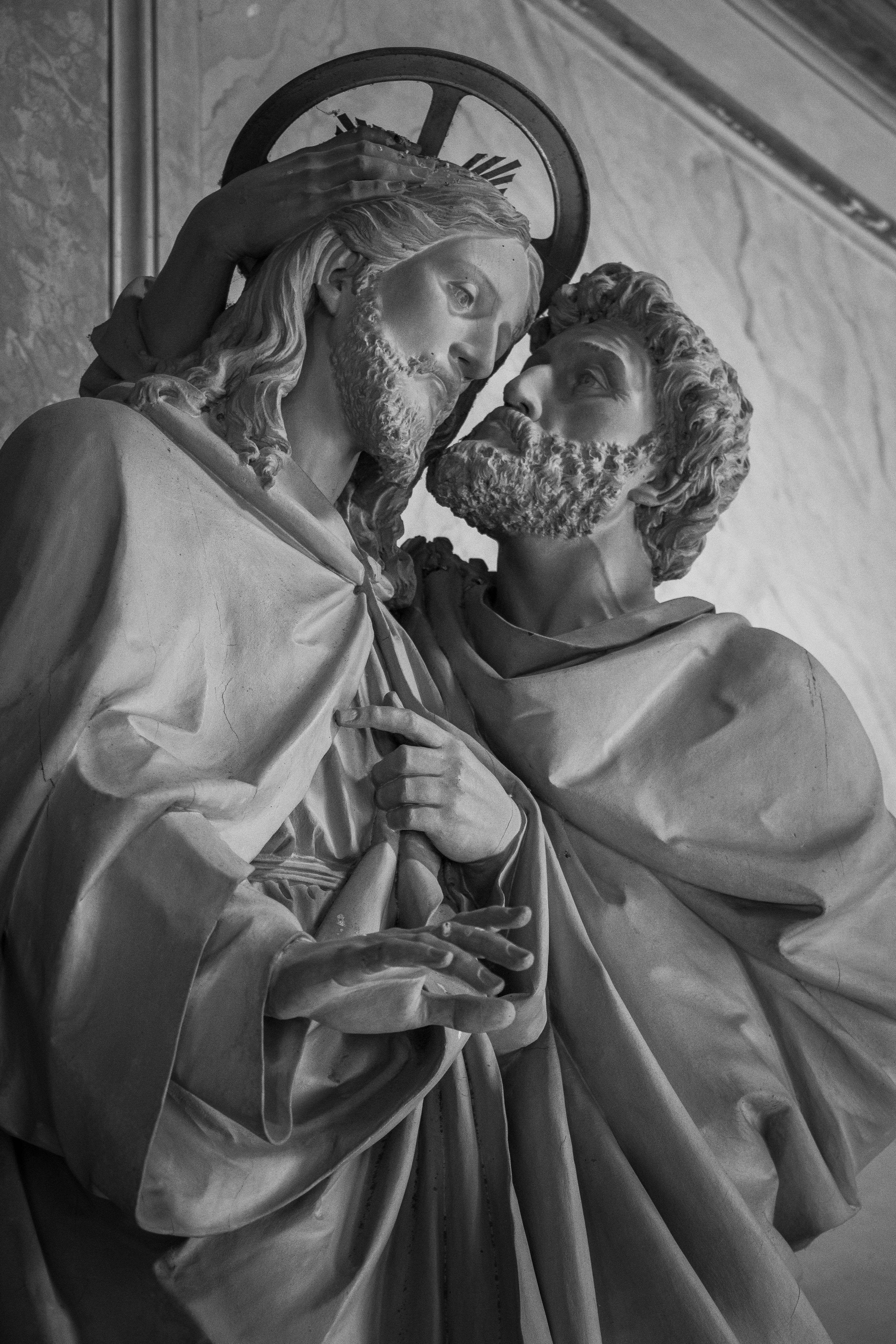 A black and white photo of a statue of jesus