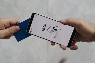 A person holding a cell phone in their hand