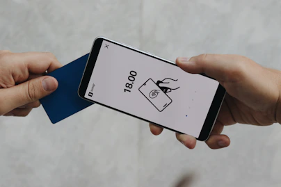 A person holding a cell phone in their hand