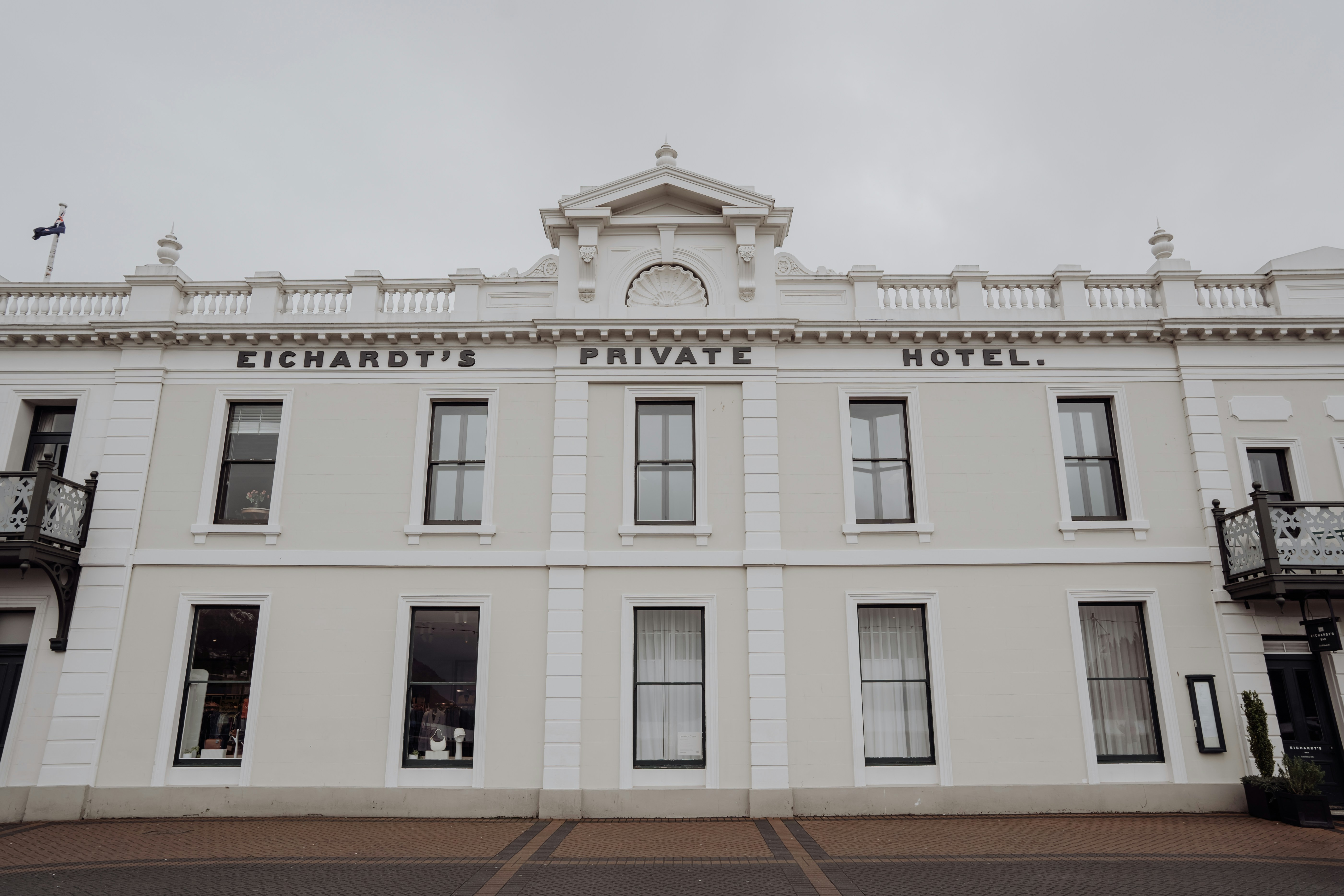 A large white building sitting on the side of a road