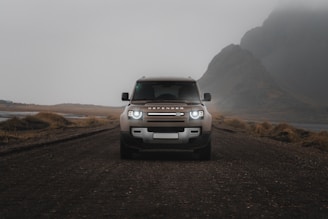A jeep is driving down a dirt road