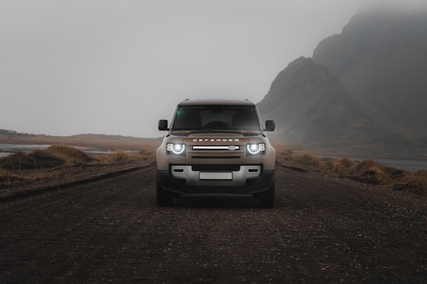 A jeep is driving down a dirt road