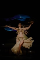 A woman in a belly dance costume is dancing