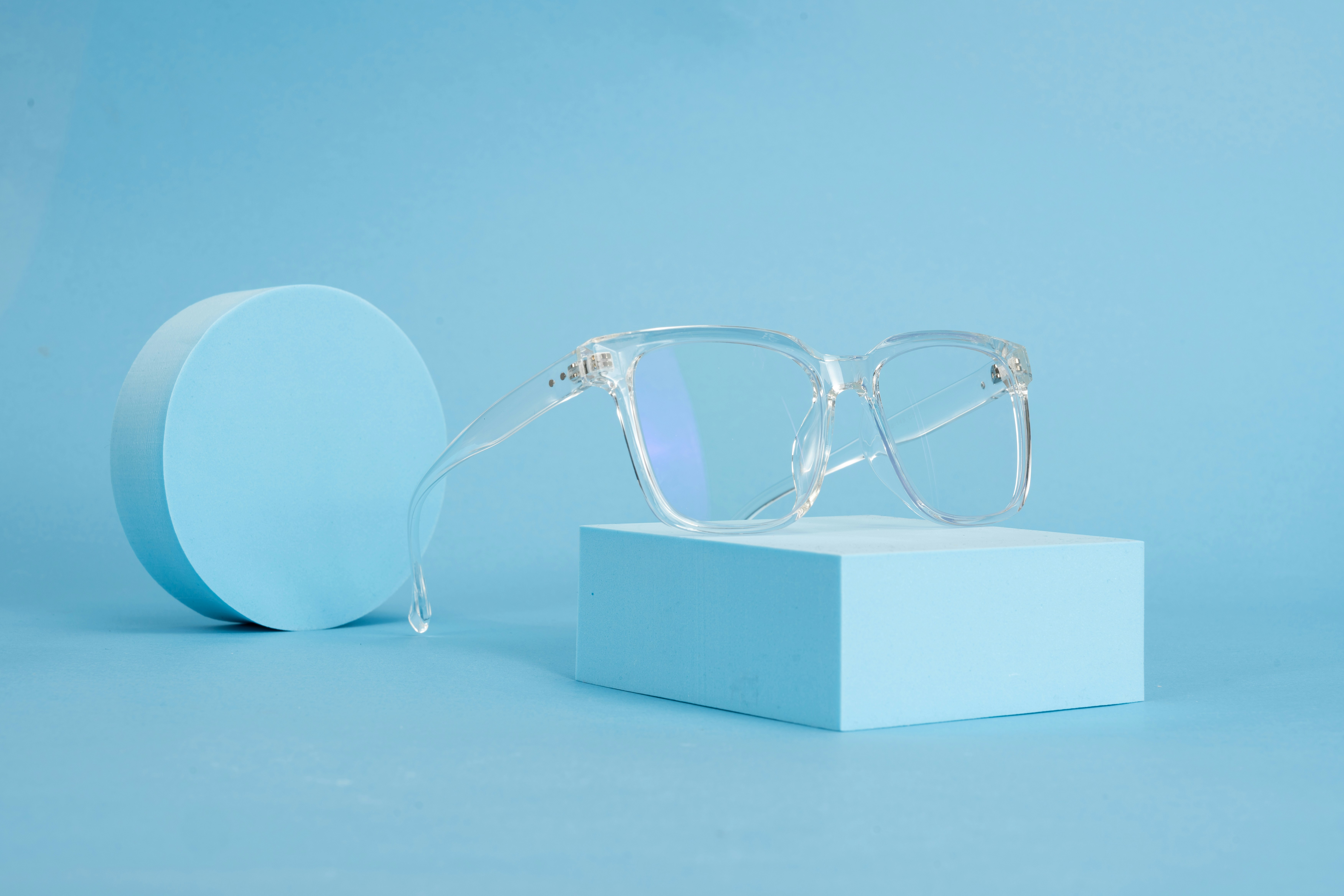 A pair of glasses sitting on top of a blue box
