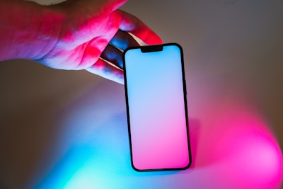 A person holding a cell phone in their hand