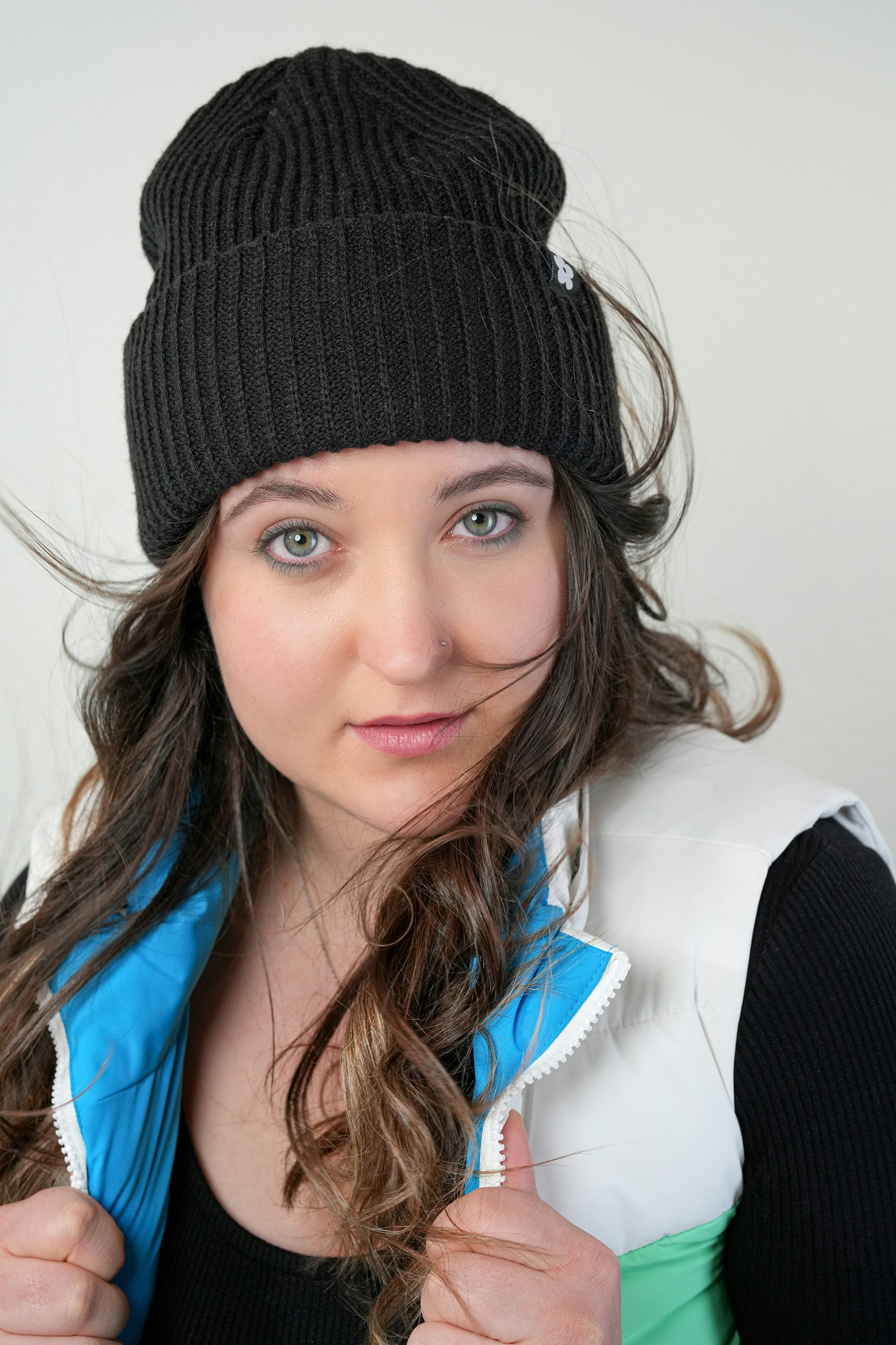 A woman wearing a black hat and jacket