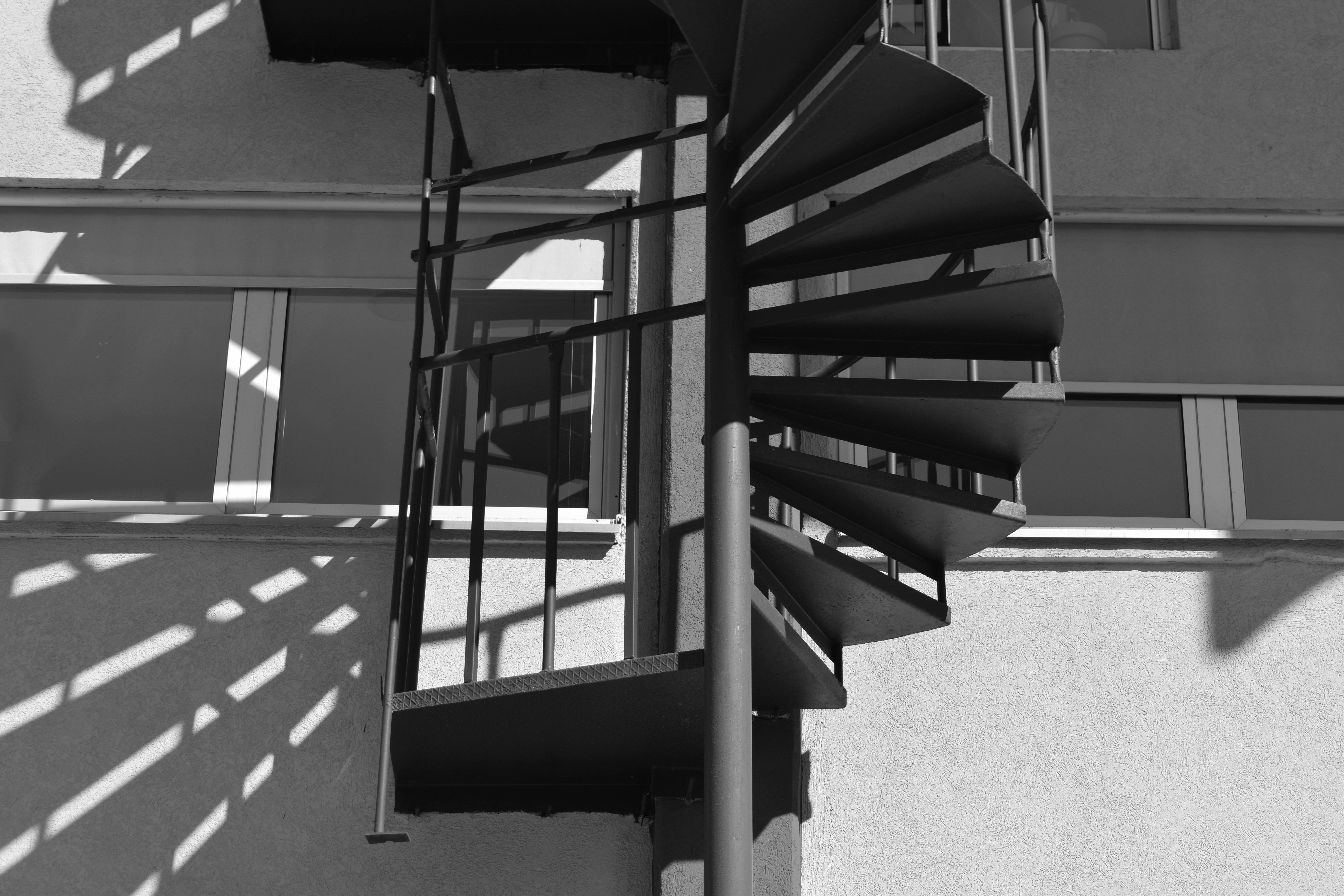 A black and white photo of a spiral staircase