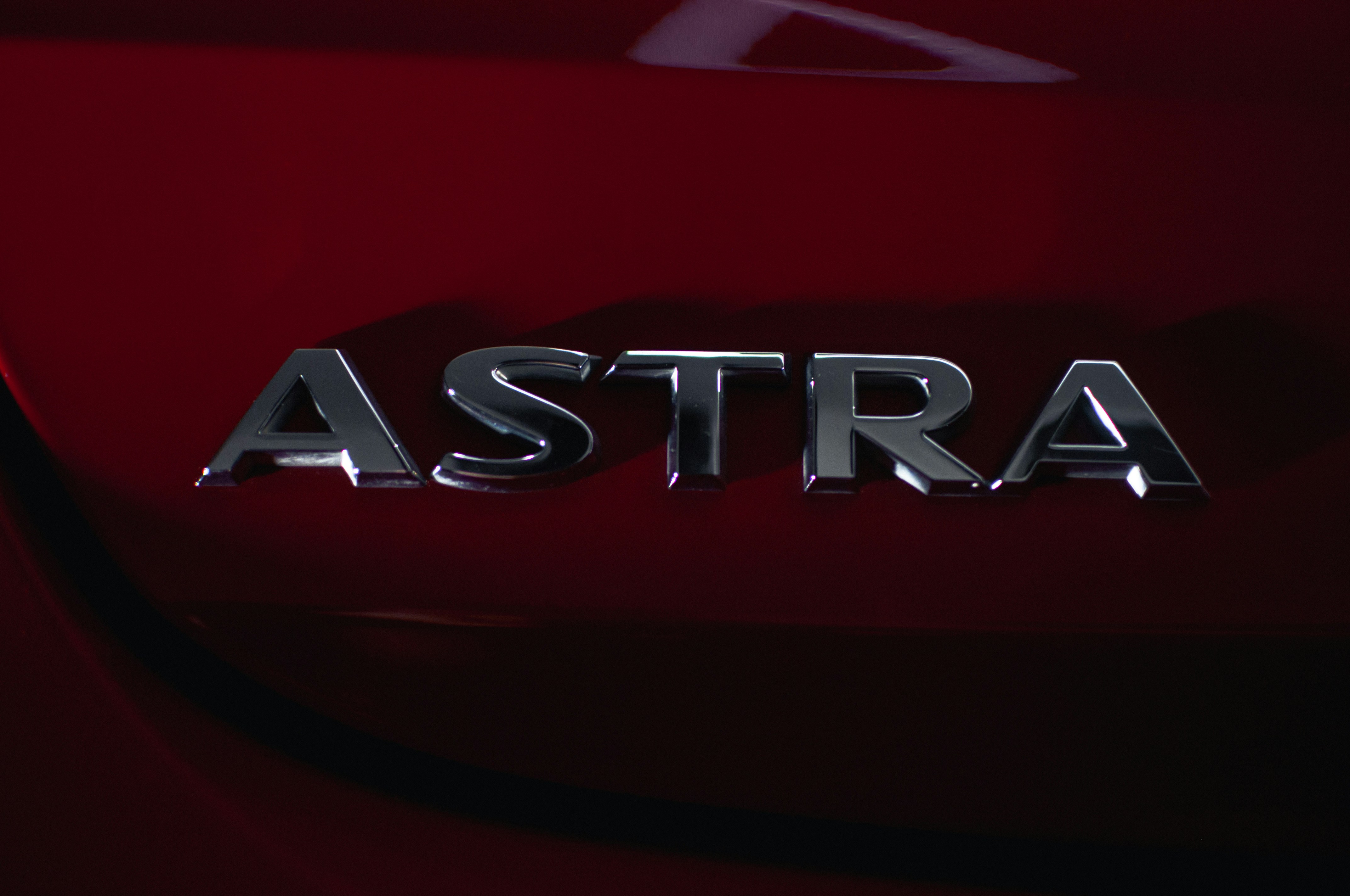 A close up of the logo on a red car