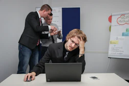 A man sitting in front of a laptop computer