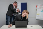 A man sitting in front of a laptop computer
