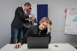 A man sitting in front of a laptop computer