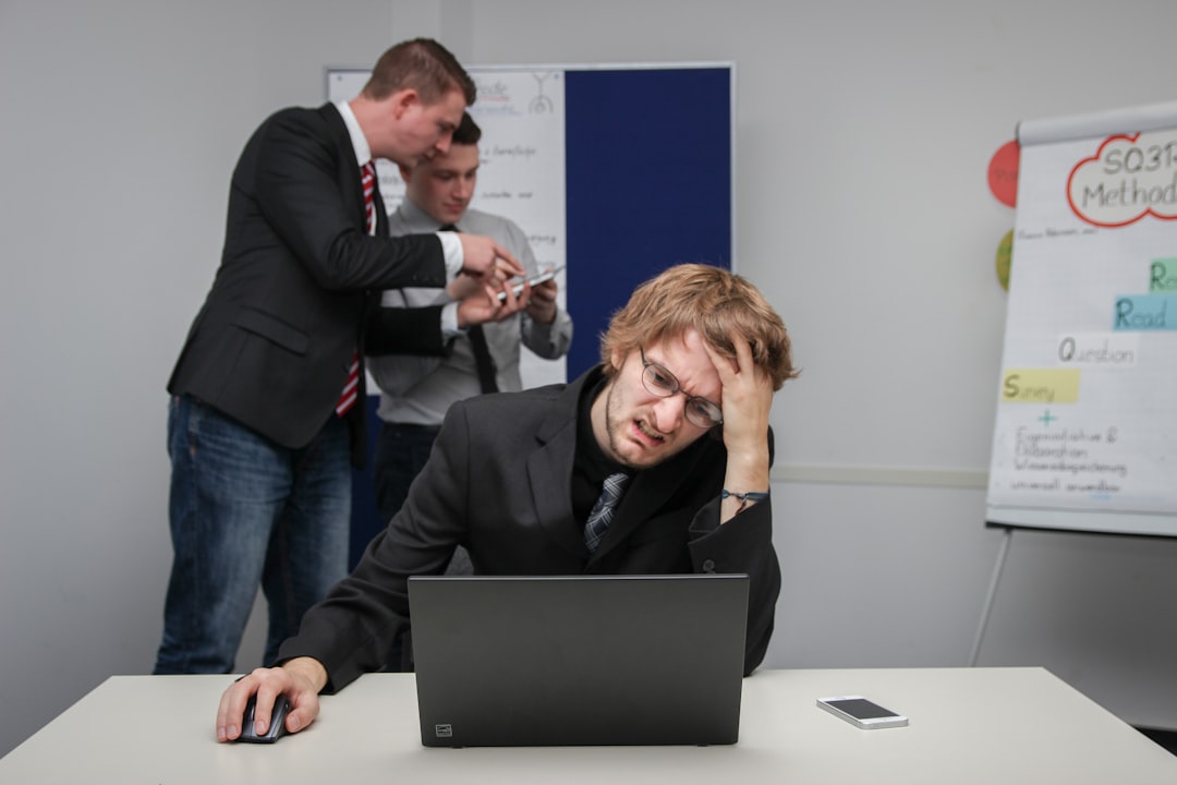 A man sitting in front of a laptop computer,
