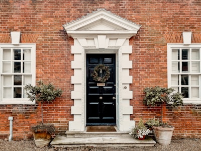 A brick building with a black door and windows